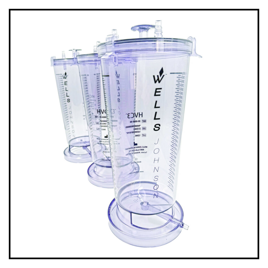 Clear measuring containers with Wells Johnson branding.